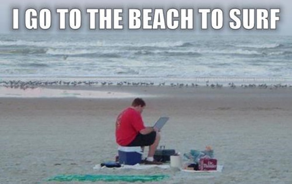Beach Puns - Man on the Beach Surfing the Internet