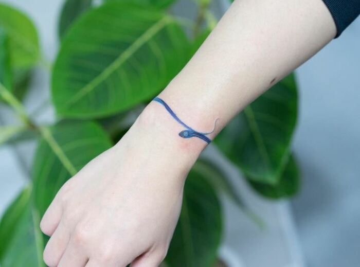 Minimalist tattoos - snake around wrist