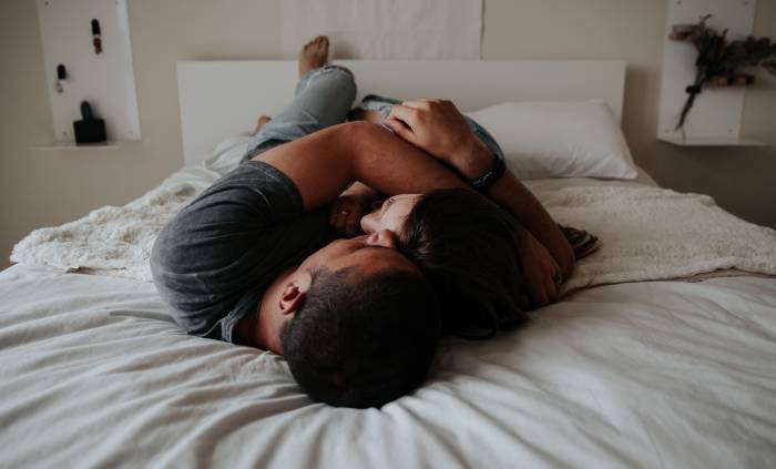 Signs a Man is Attracted to You Sexually - laying in bed