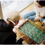 How to make friends as an adult - people playing foosball