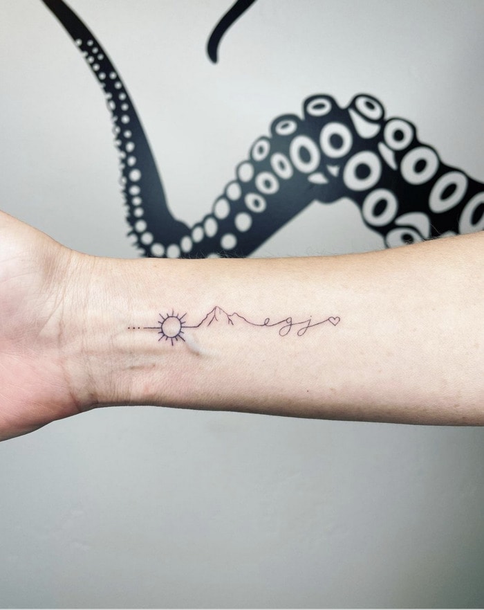 Small Wrist Tattoos - sun and mountain