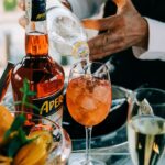 Aperol vs Campari - pouring Aperol on a glass