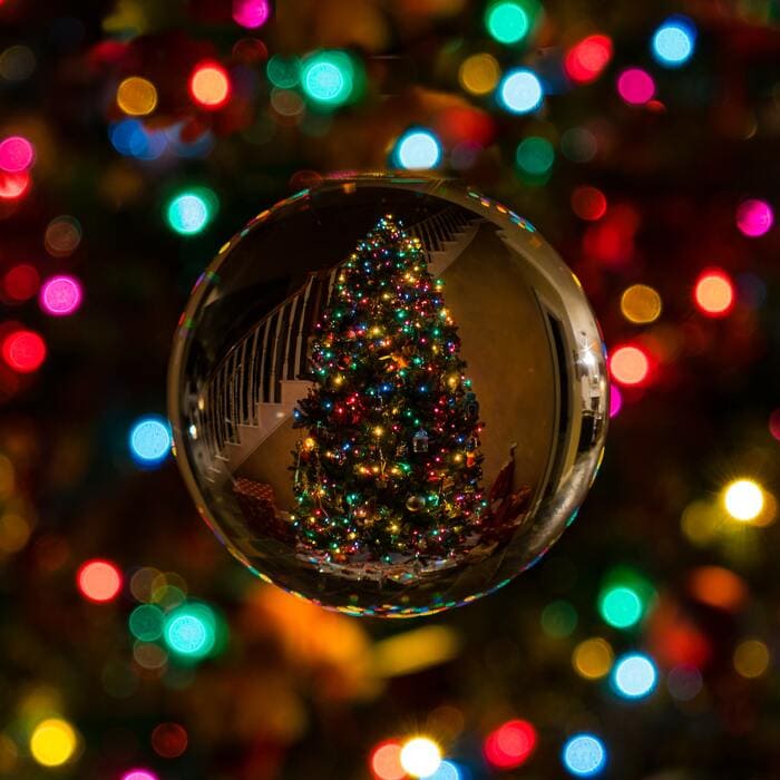 Christmas Puns Jokes - Christmas Tree Reflection on a Christmas Ball