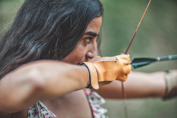 Physically Active Self Care Ideas - woman aiming bow