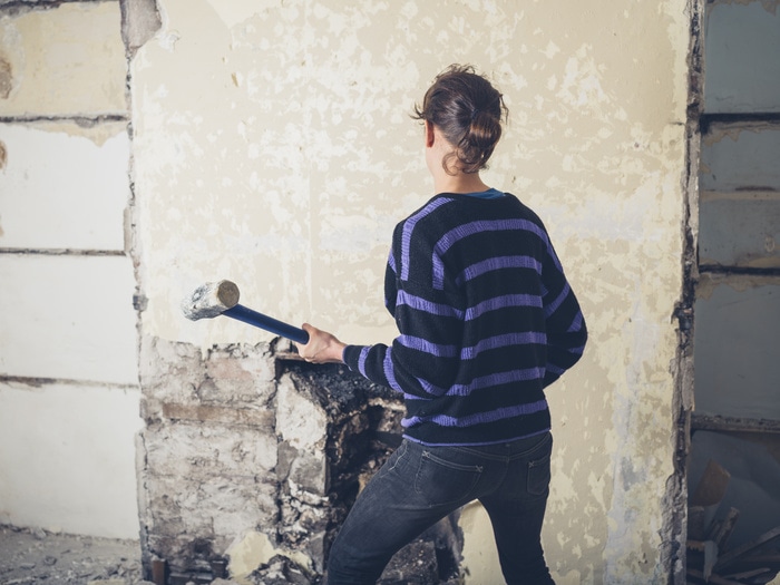 Physically Active Self Care Ideas - woman knocking down wall with sledgehammer