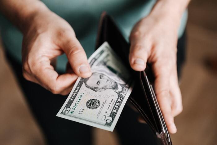 How to Stop Spending Money - cash in wallet