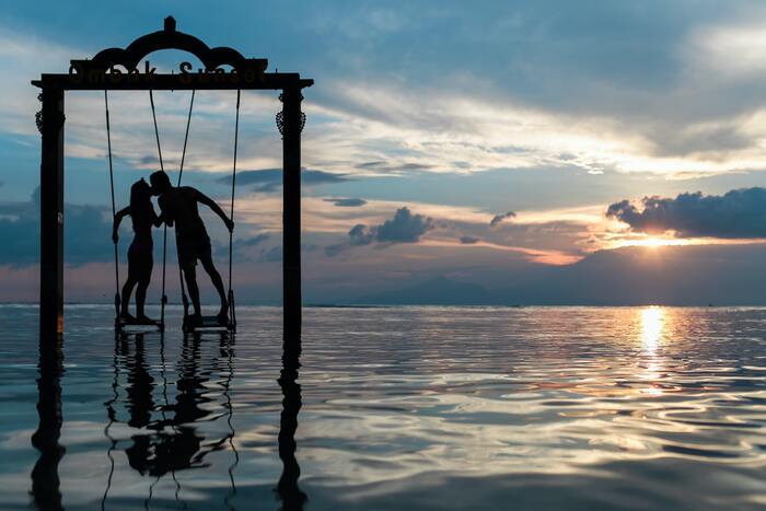 February Horoscope 2023 - couple in water at sunset