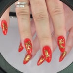 Aries Nails - Red and gold lettering
