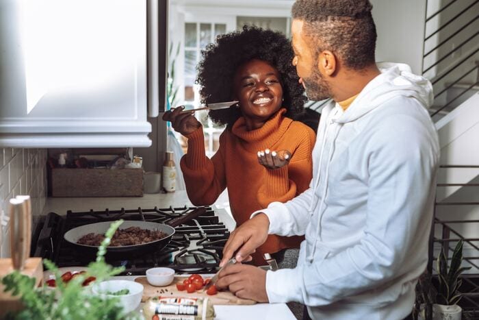 what to ask before you move in together - couple cooking together
