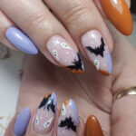 fall nail design ideas 2023 - lavender and orange with black bats and ghosts